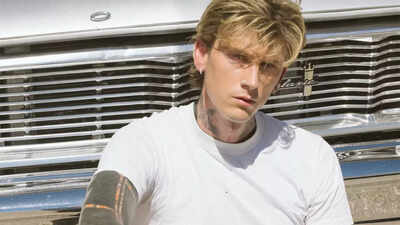 Machine Gun Kelly shows off new ear tattoos at Clive Davis Grammys party |